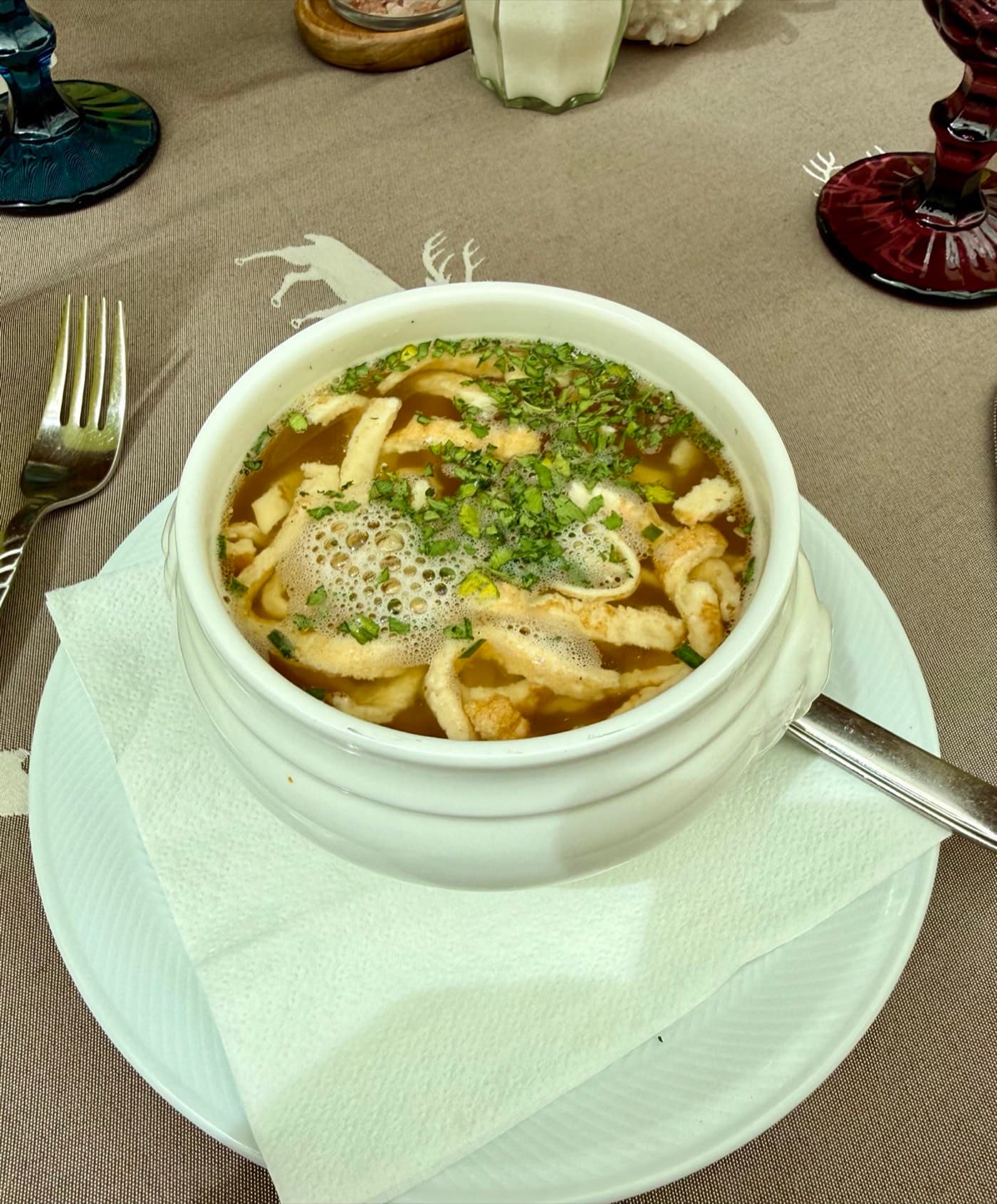 Clear broth with thin pancake strips and fresh chives at Zentrum Café Restaurant