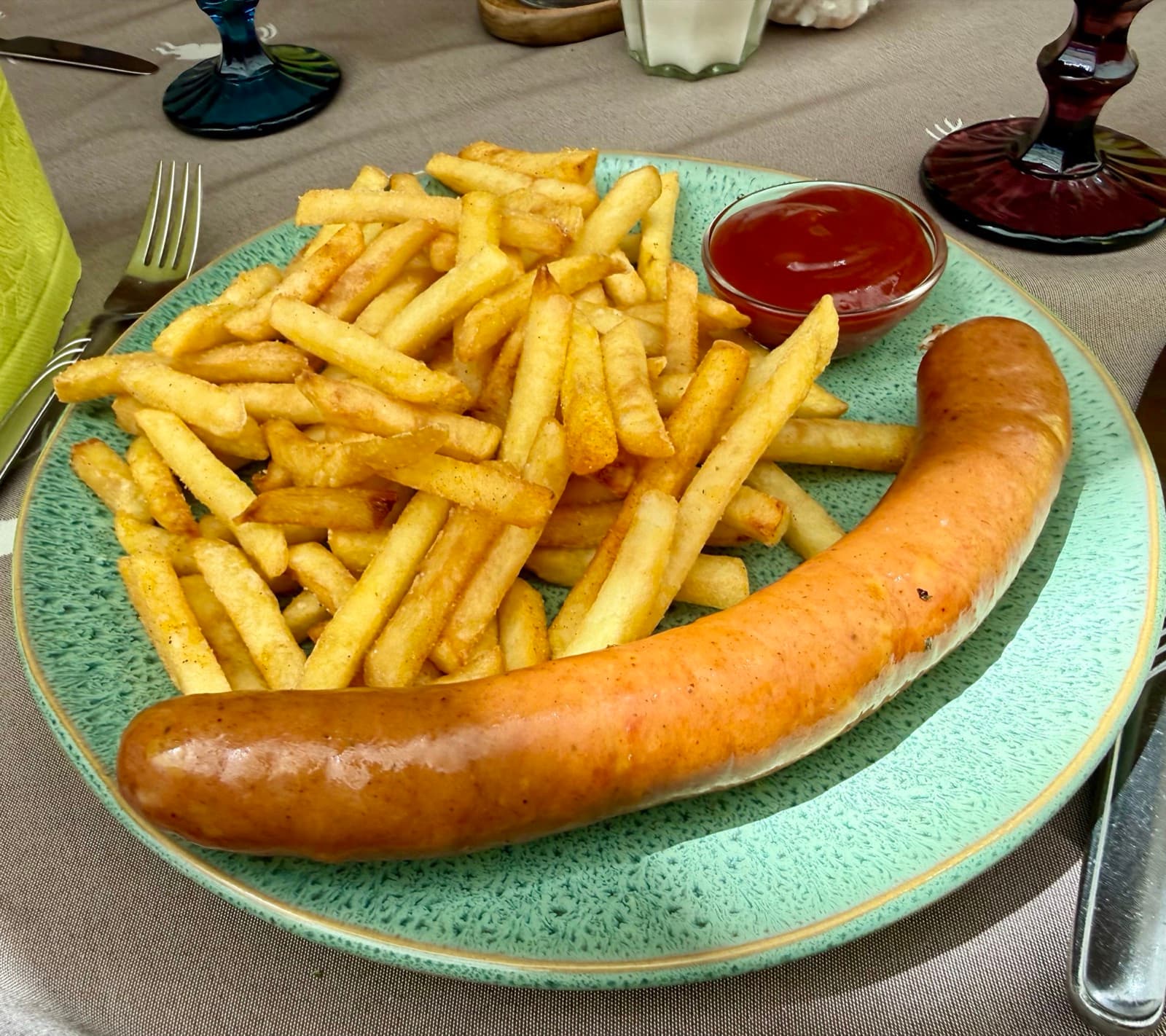 Grilled Käsekrainer cheese sausage served with golden fries at Zentrum Café Restaurant
