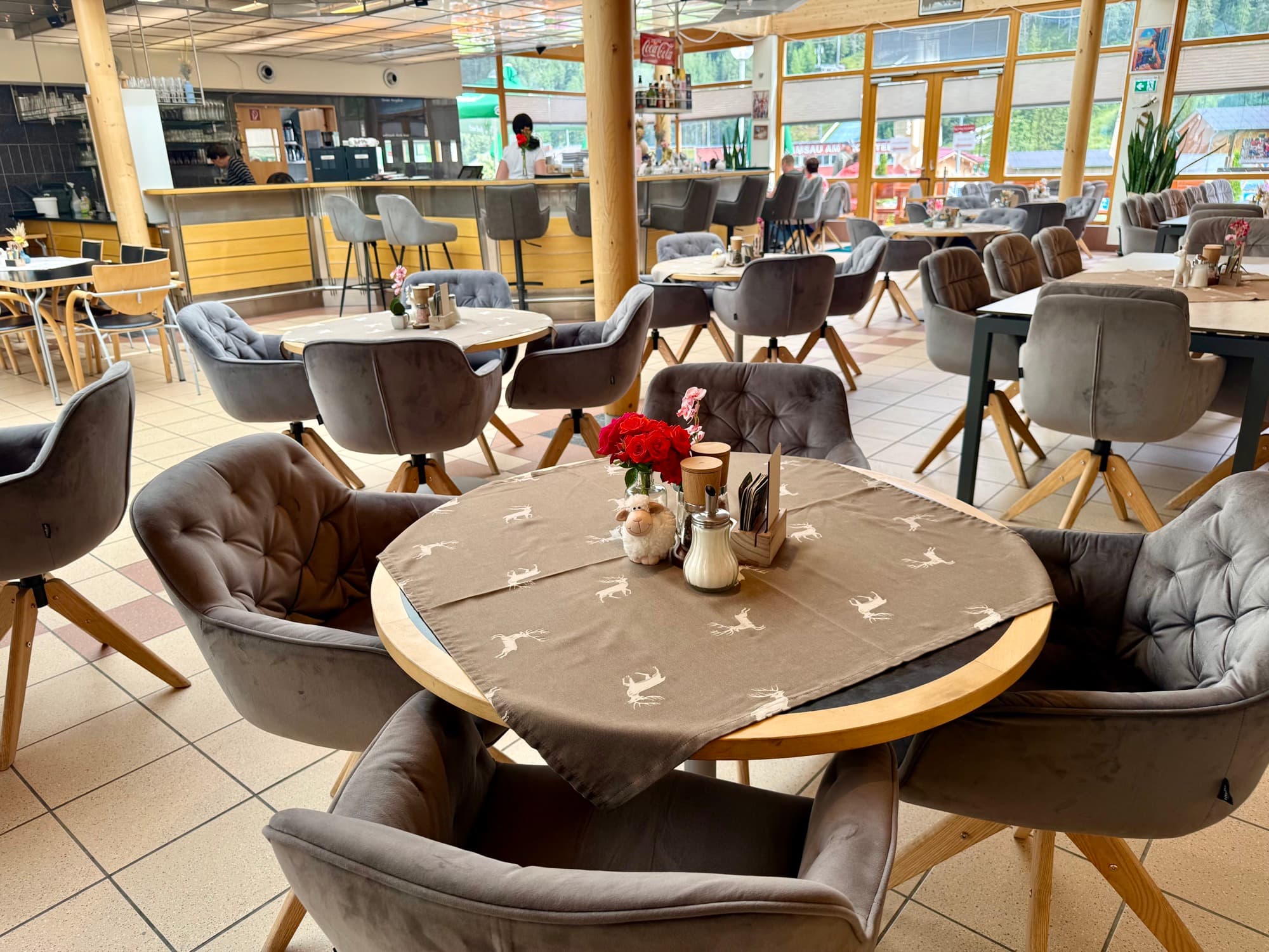 Wooden benches and tables on the terrace of Zentrum Café Restaurant on a sunny day